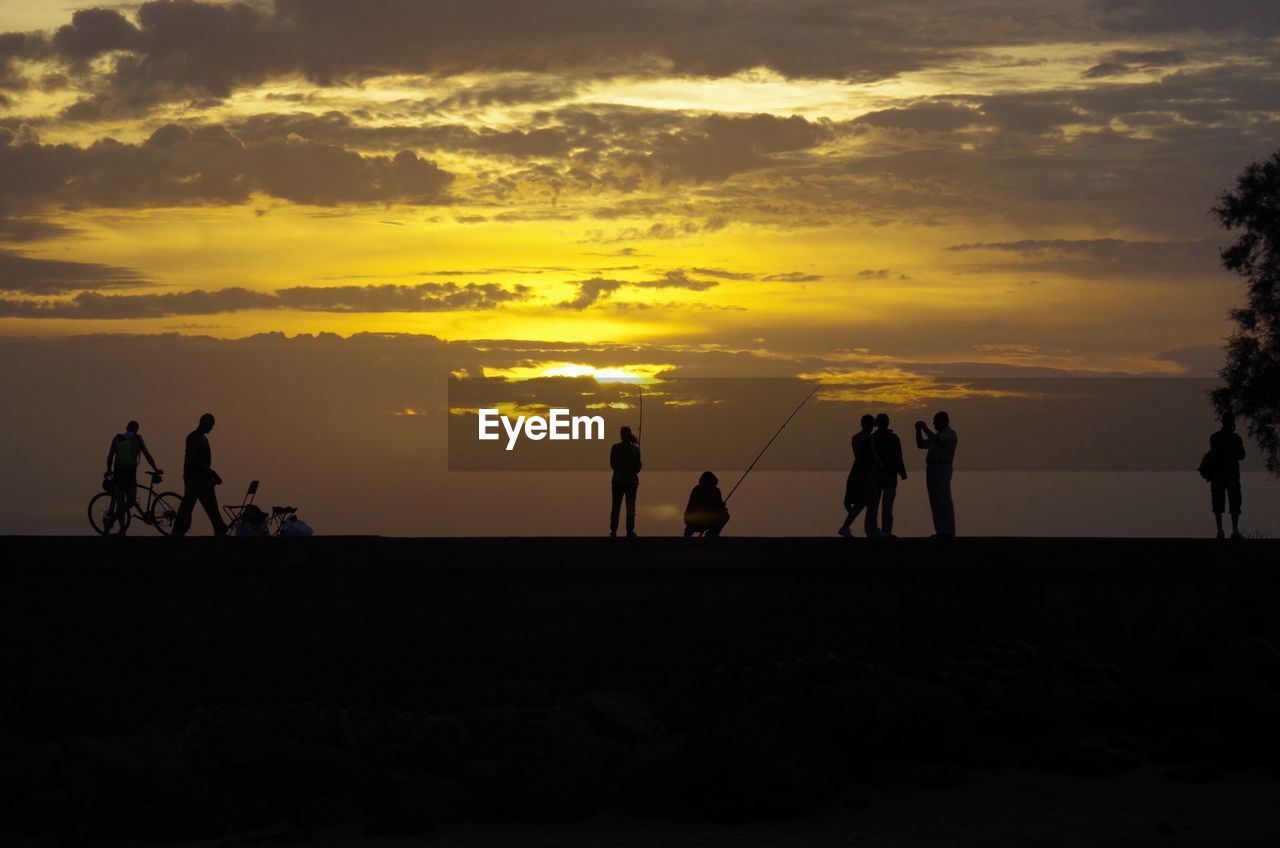 Silhouette of people at beach 