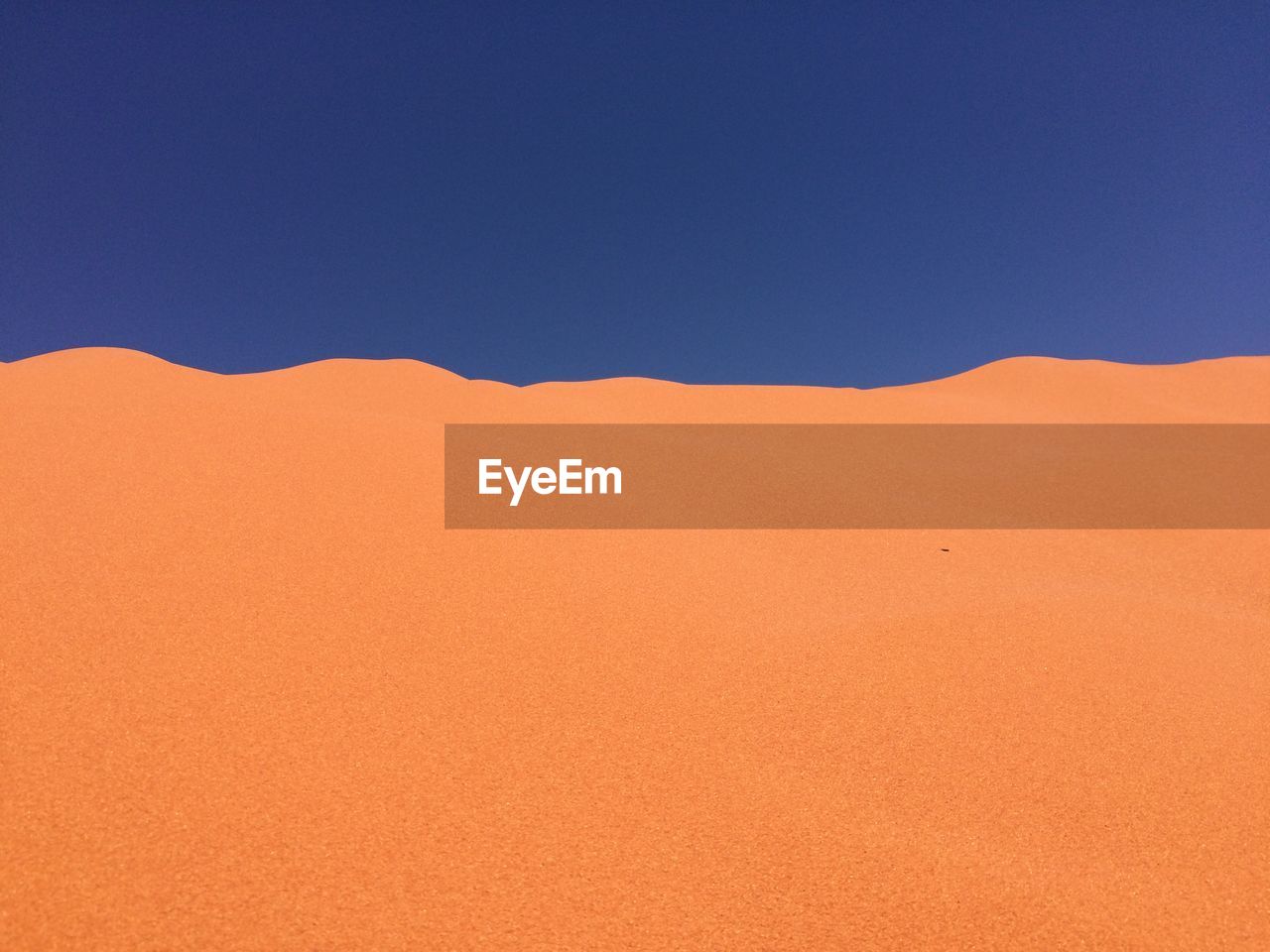 VIEW OF DESERT AGAINST CLEAR BLUE SKY