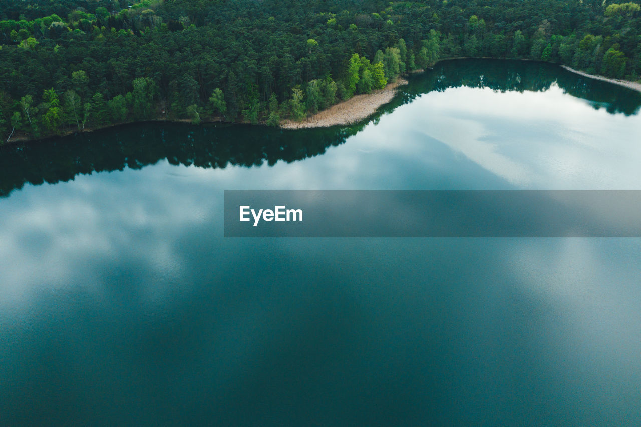 REFLECTION OF TREES ON LAKE