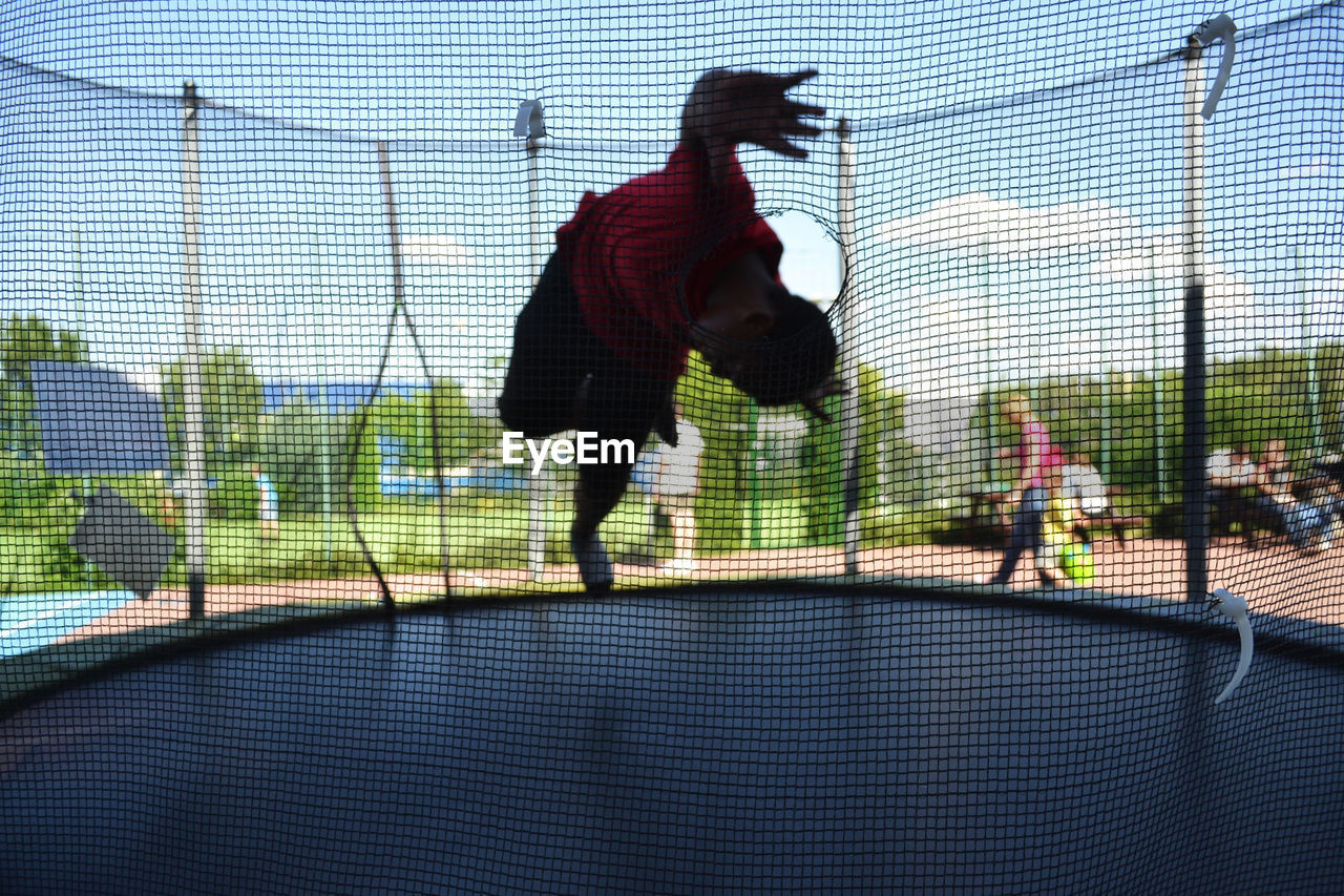 BLURRED MOTION OF MAN PLAYING IN THE FARM