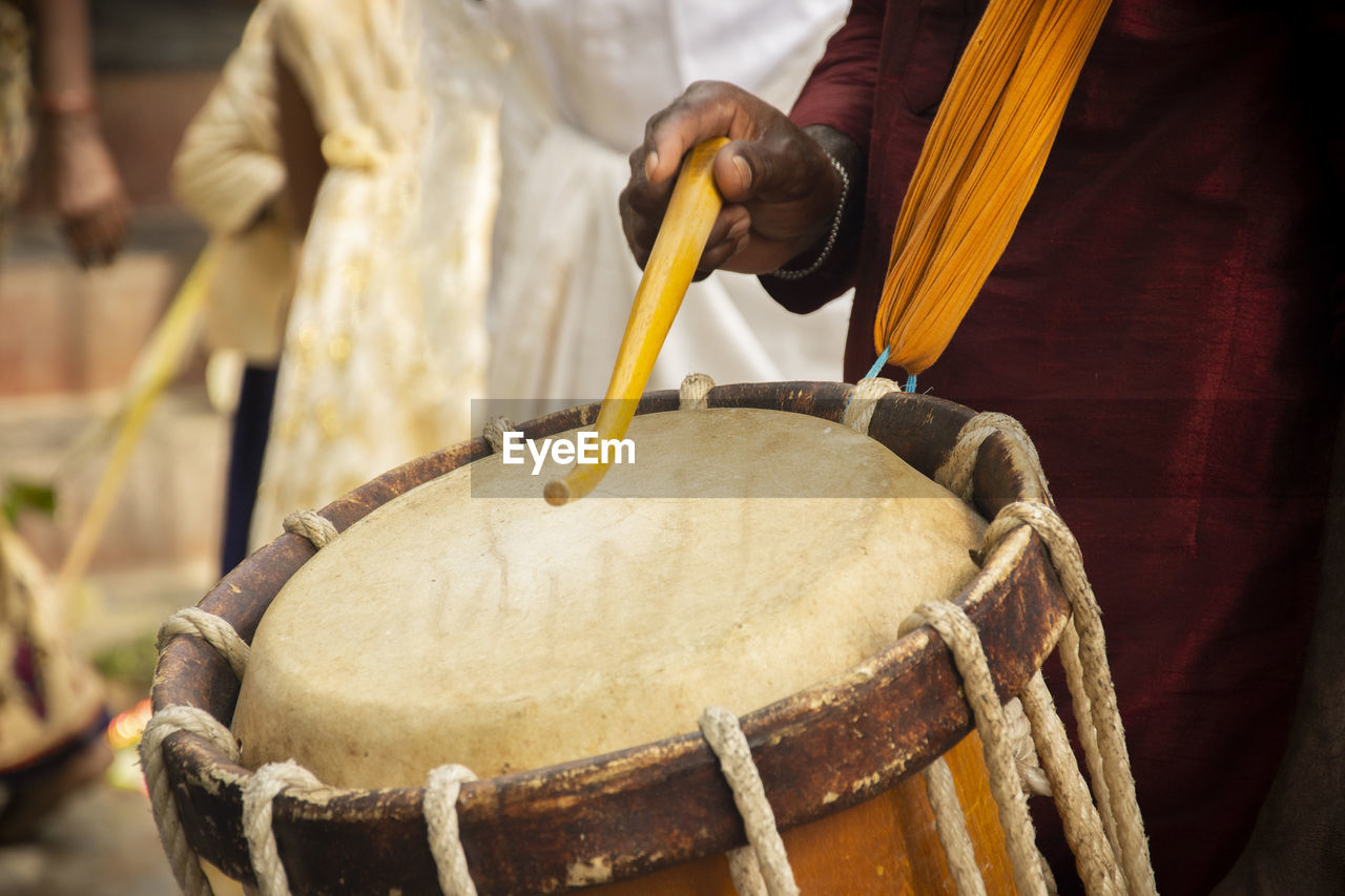 Close-up of man playing drum