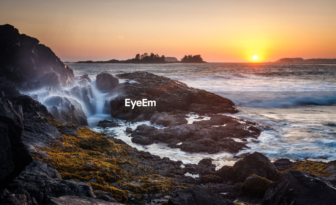 Scenic view of sea against clear sky during sunset