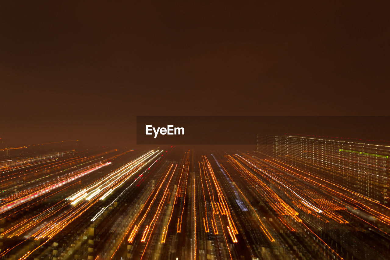 High angle view of light trails on road against sky at night