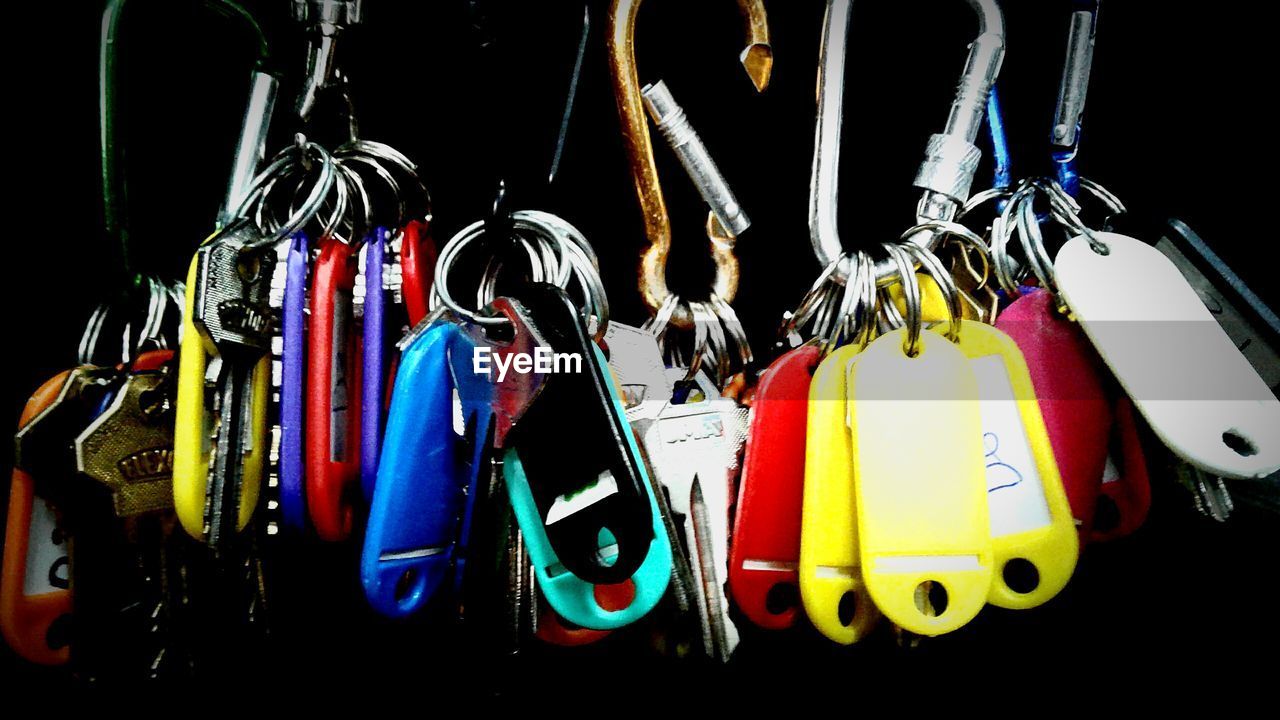 CLOSE-UP OF MULTI COLORED CLOTHES HANGING ON SHELF