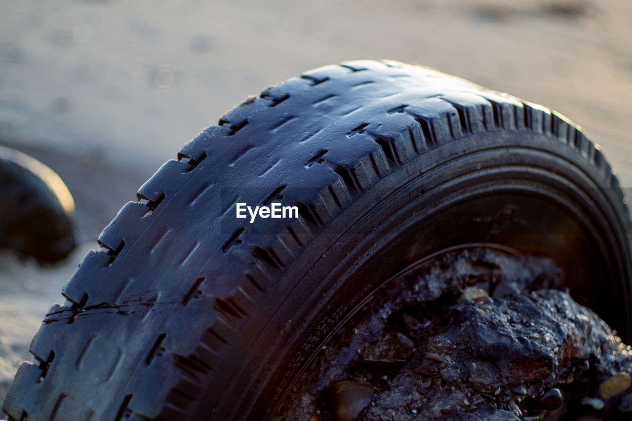 Close-up of tire at beach