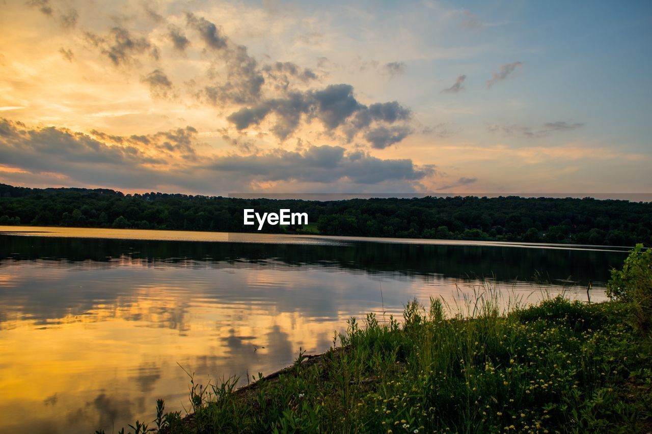 Scenic view of lake against sky during sunset