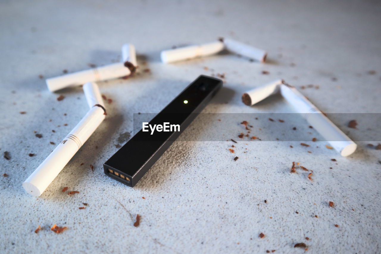 HIGH ANGLE VIEW OF CIGARETTE ON WOODEN TABLE