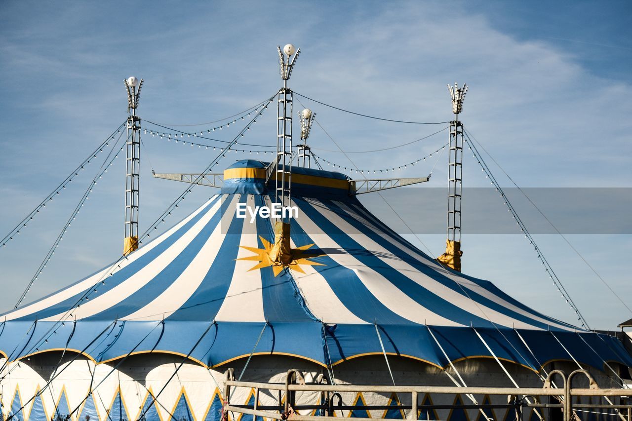 Low angle view of circus tent  cloudy sky