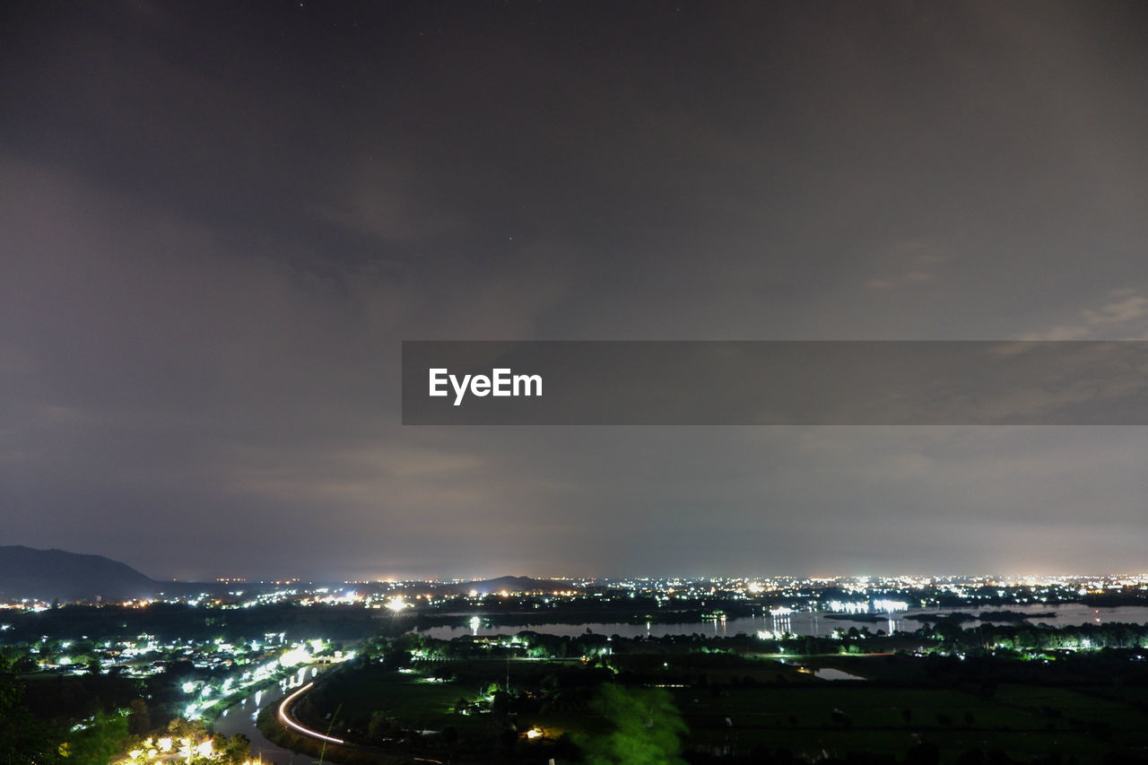 High angle view of illuminated city against sky at night