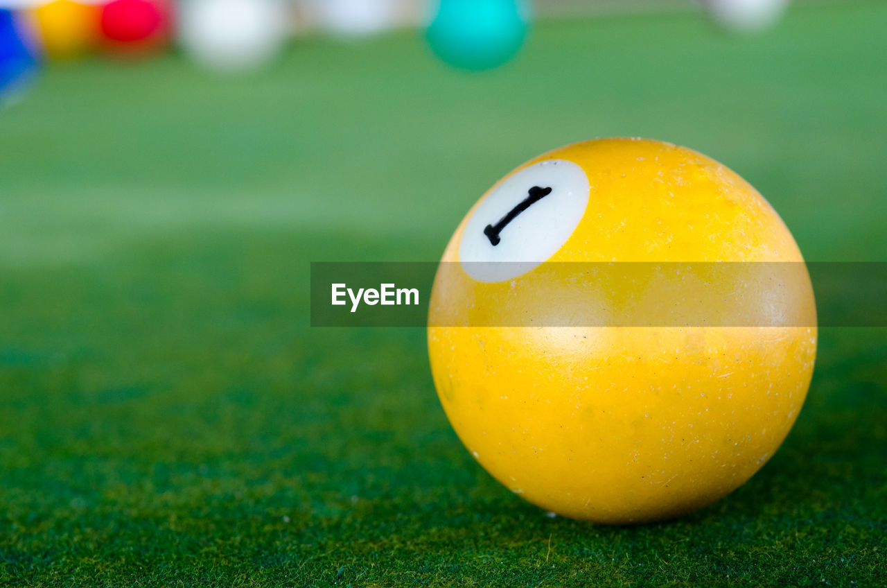 Close-up of yellow ball on pool table