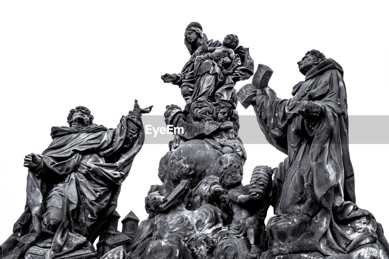 Low angle view of statues against clear sky