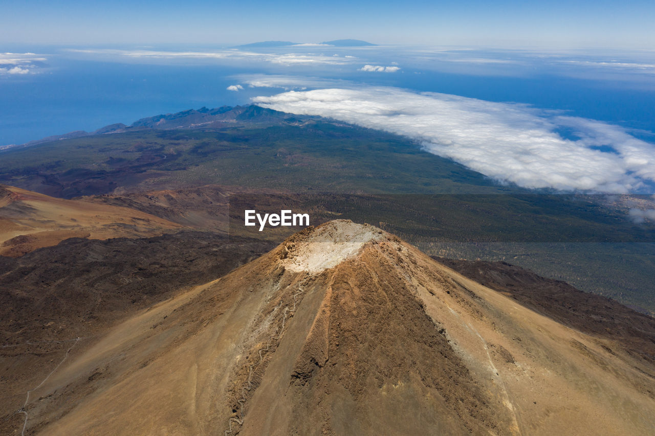 Summit of volcano teide with island la gomera in the backgroung at sunny day.