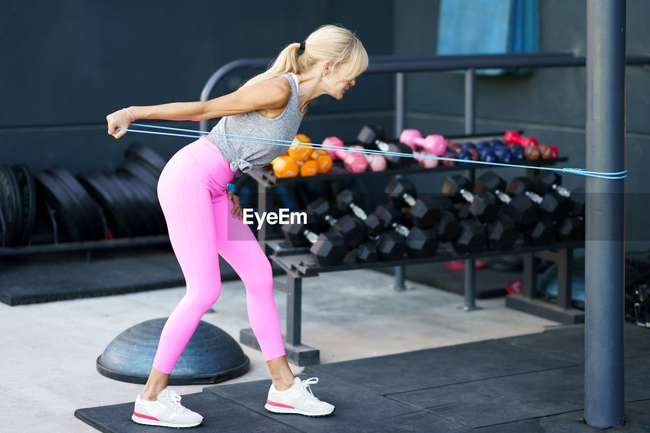 side view of woman exercising at gym