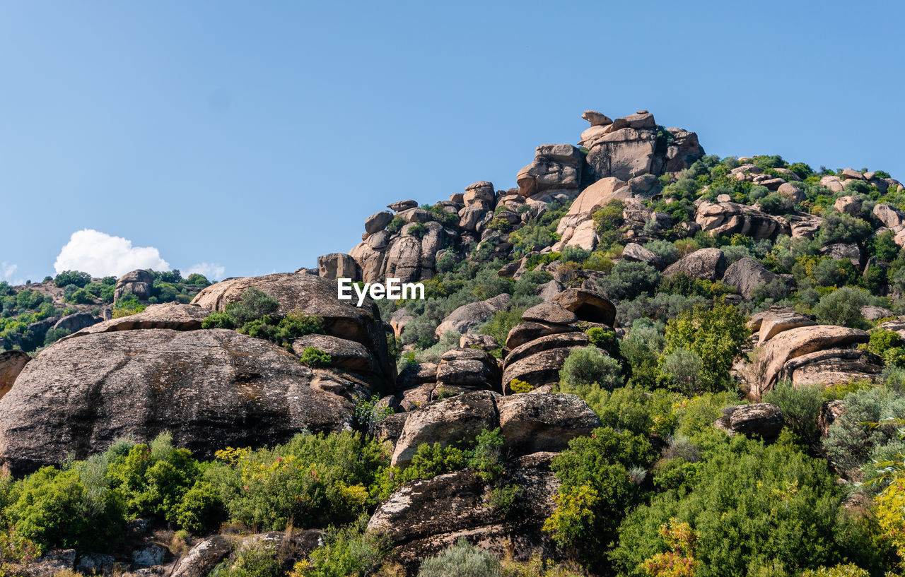 Low angle view of rock formations against sky