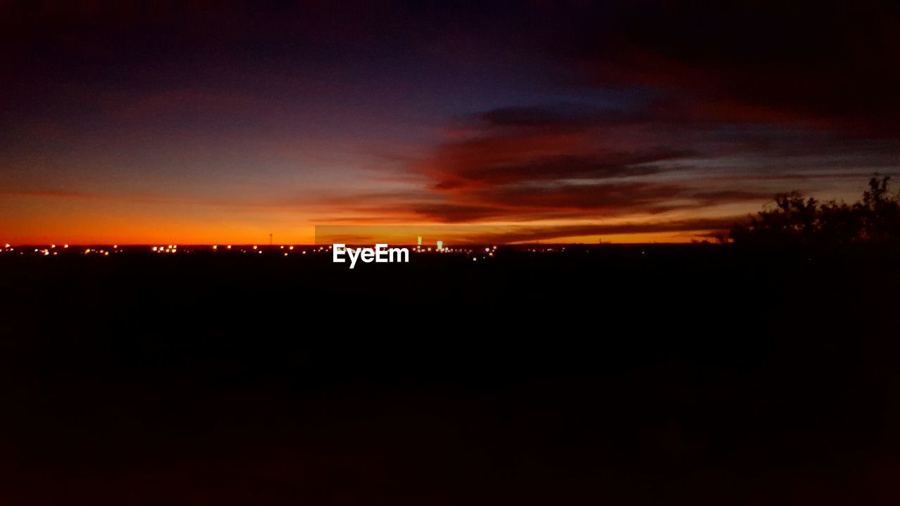 SCENIC VIEW OF SILHOUETTE LANDSCAPE AGAINST SKY AT SUNSET