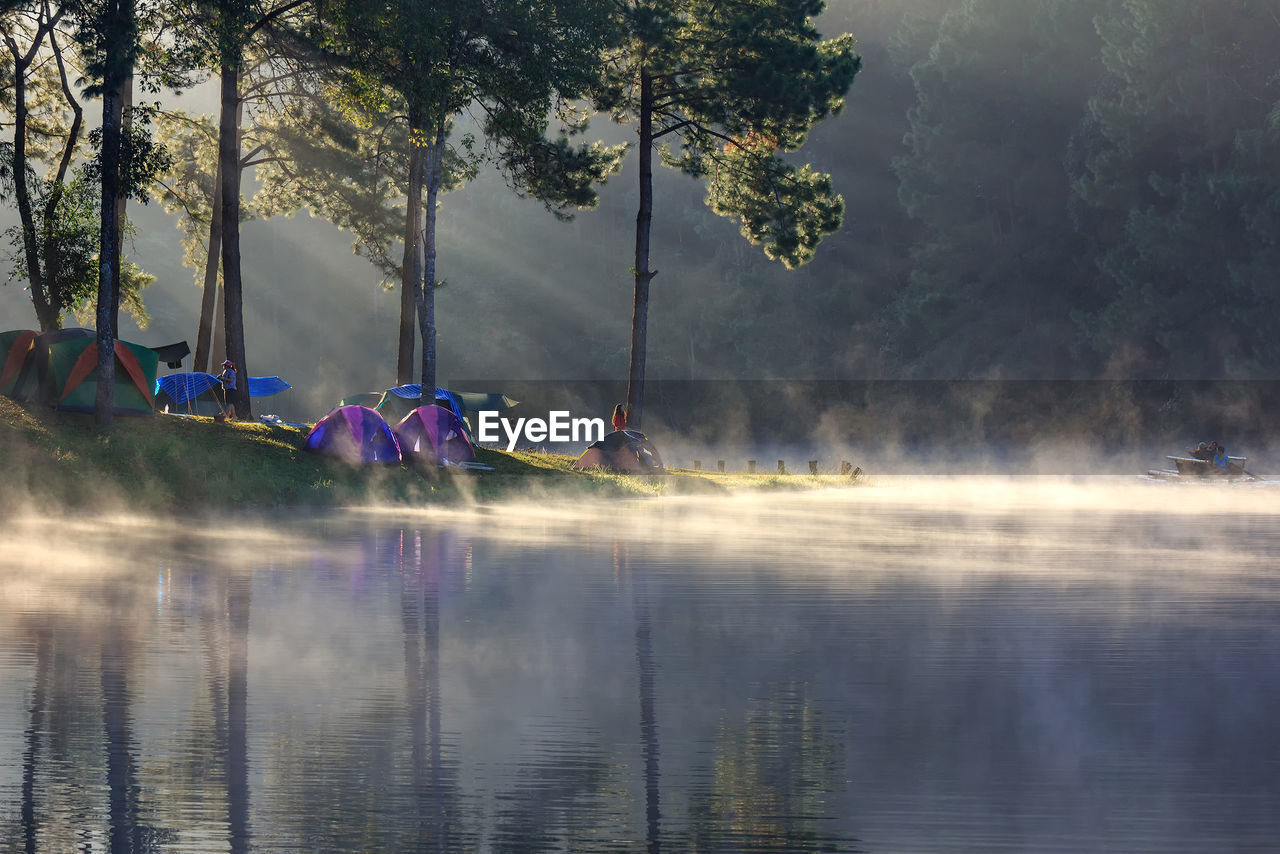 Woman camping by lake