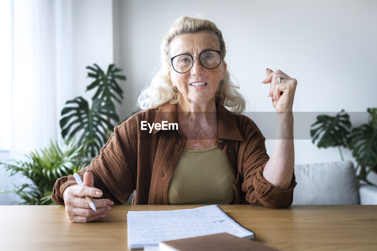 Smiling freelancer with vitiligo skin at desk in home office