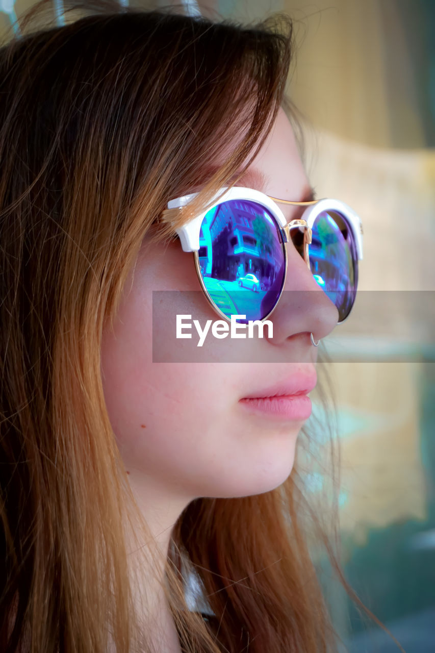 Close-up of young woman wearing sunglasses