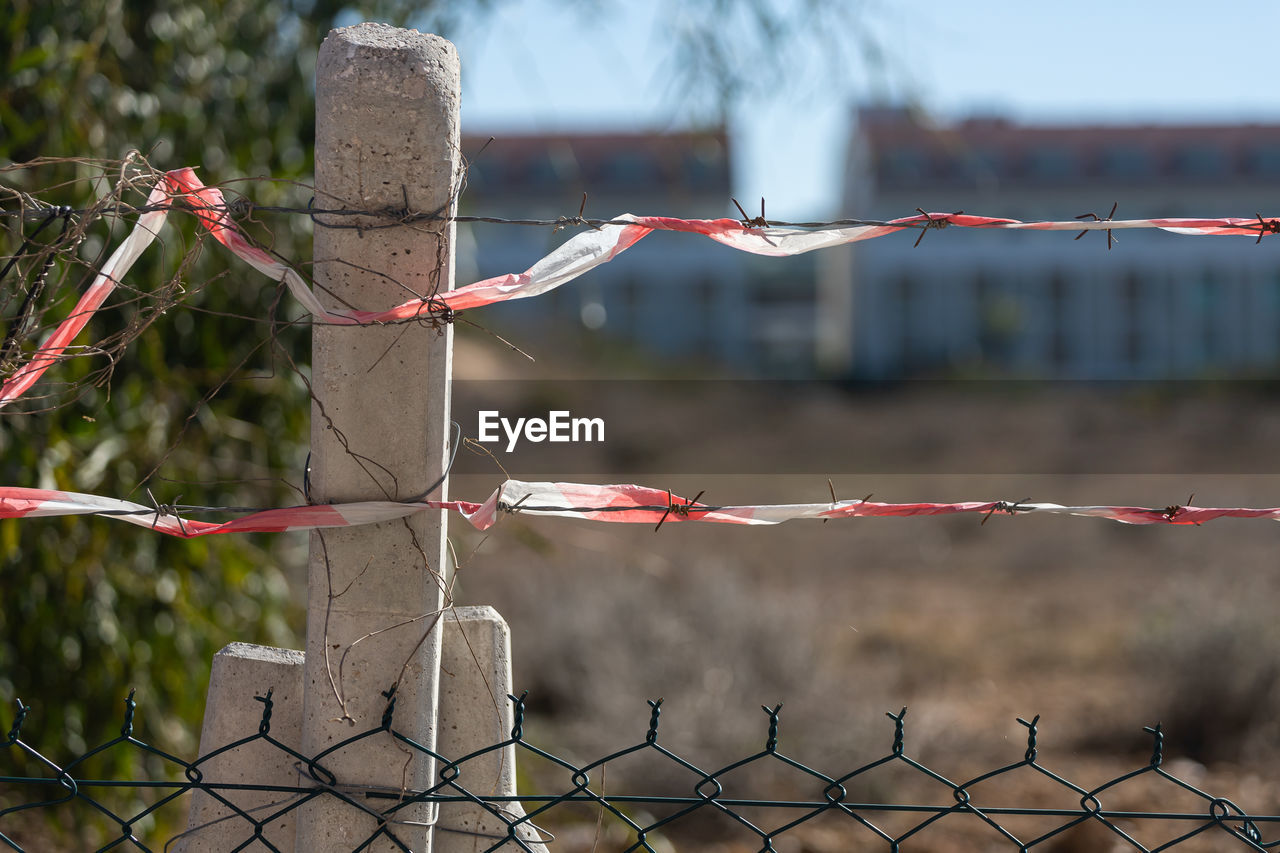 close-up of barbed wire against blurred background