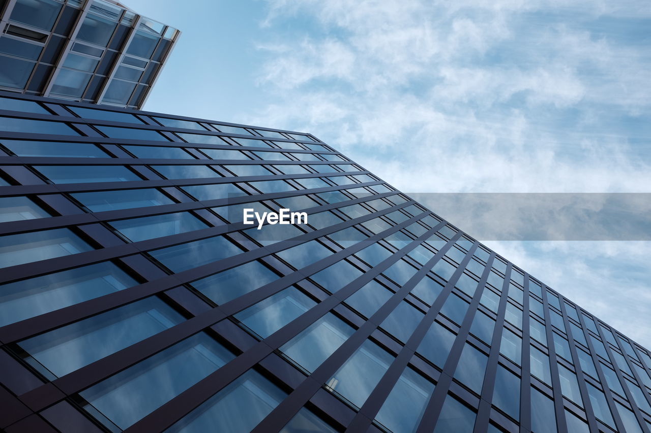 Low angle view of modern building against blue sky