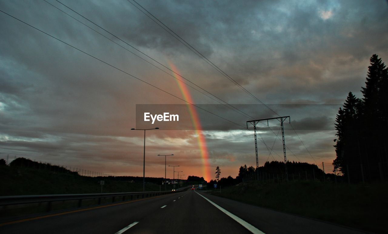 ROAD AGAINST CLOUDY SKY DURING SUNSET