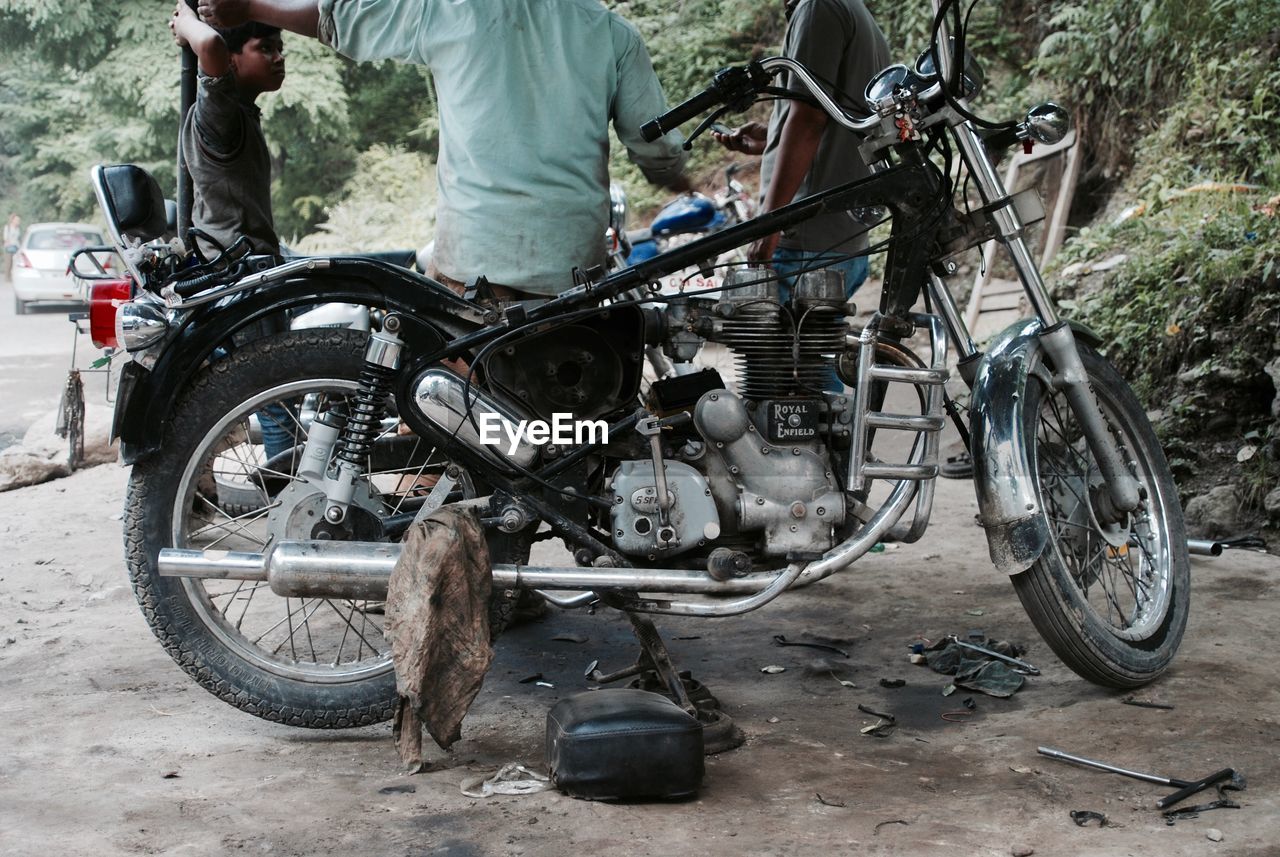 LOW SECTION OF MAN WITH BICYCLE STANDING ON CART