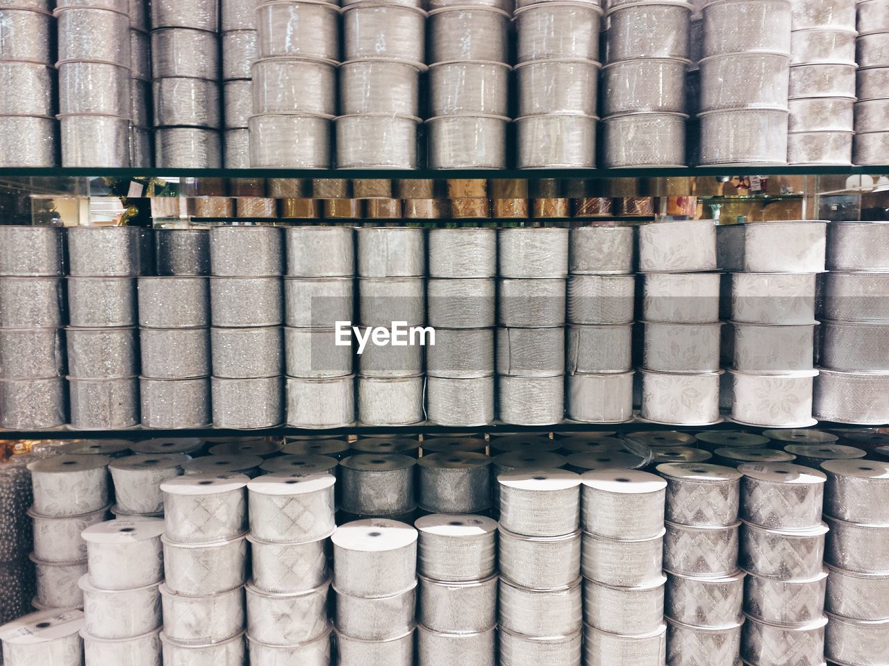 Full frame shot of rolls on shelves at factory