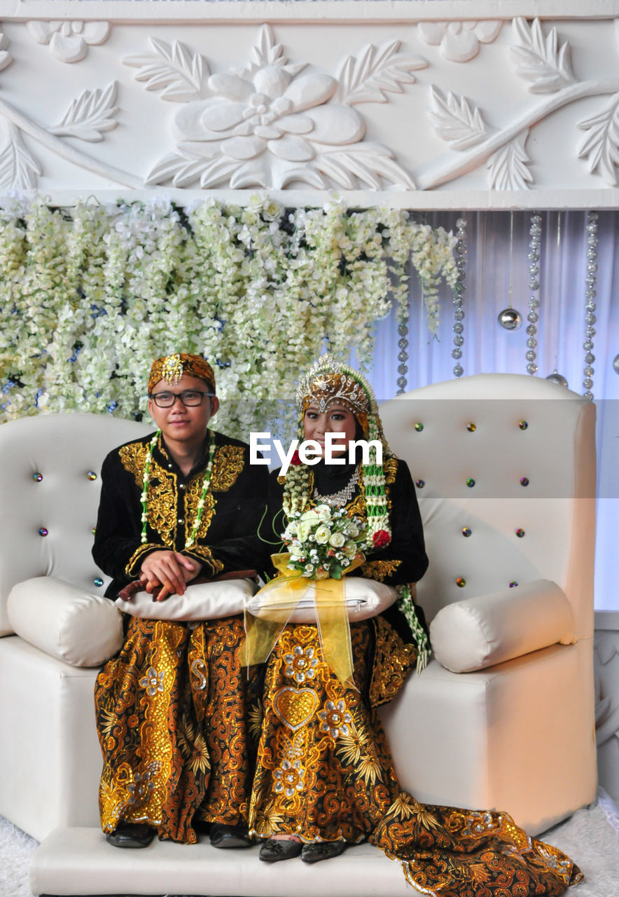 Young couple sitting in a room, wedding javanese