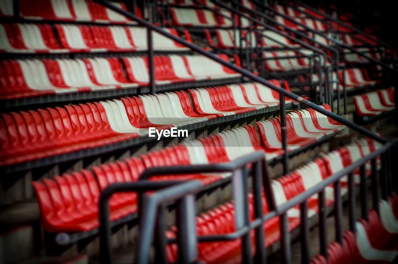 Empty red and white seats at soccer stadium