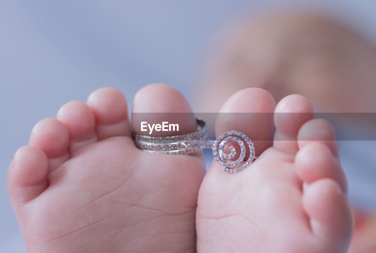 Close-up of rings on baby barefoot