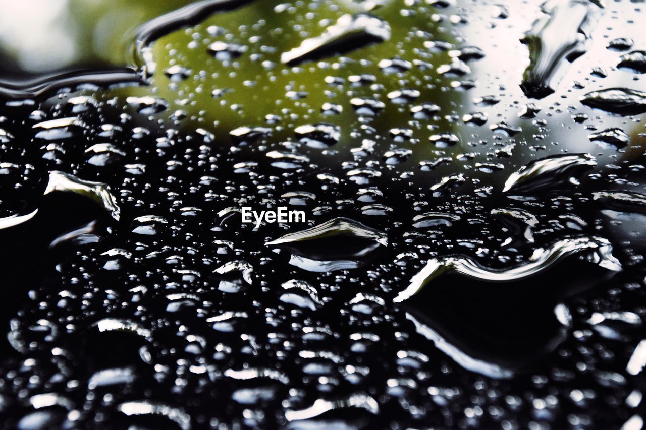 FULL FRAME SHOT OF RAINDROPS ON GLASS