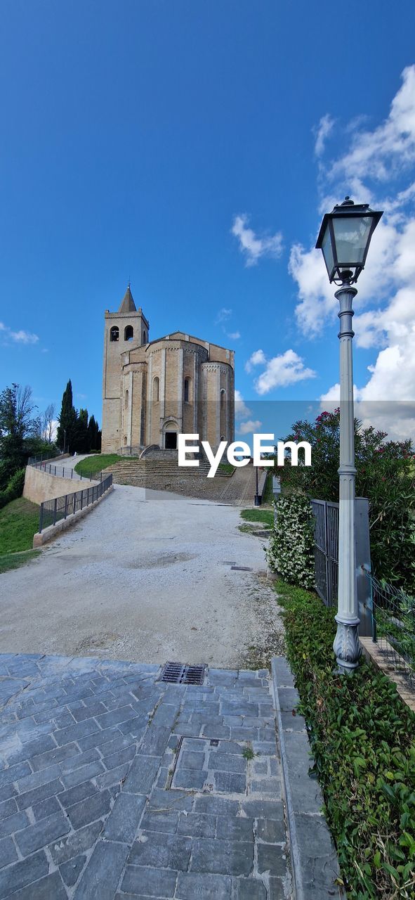 blue, architecture, sky, built structure, wall, nature, building exterior, day, building, plant, tree, cloud, no people, reflection, outdoors, wall - building feature, city, urban area, low angle view, water