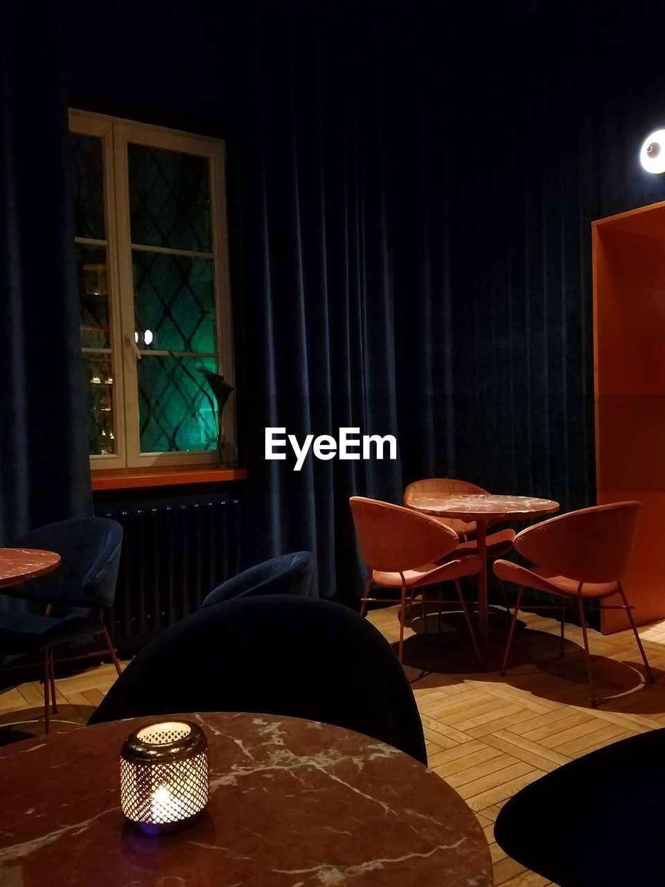 Empty chairs and table on floor at restaurant