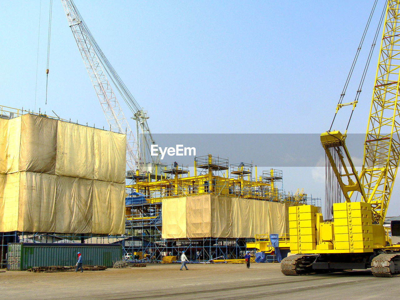 YELLOW CONSTRUCTION SITE AGAINST SKY