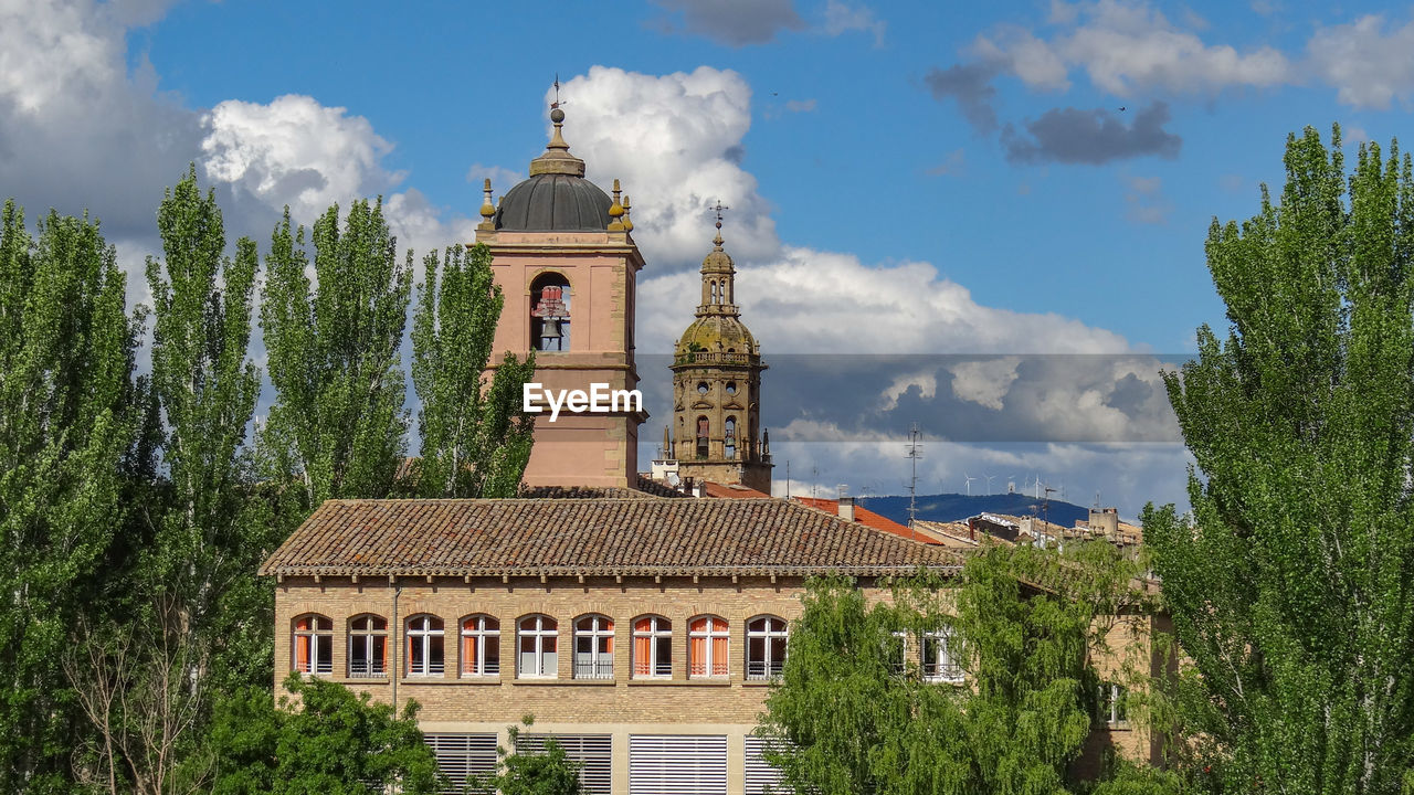 Panoramic view of trees and building against sky