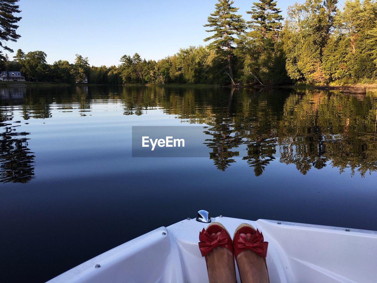Low section of woman in boat on lake