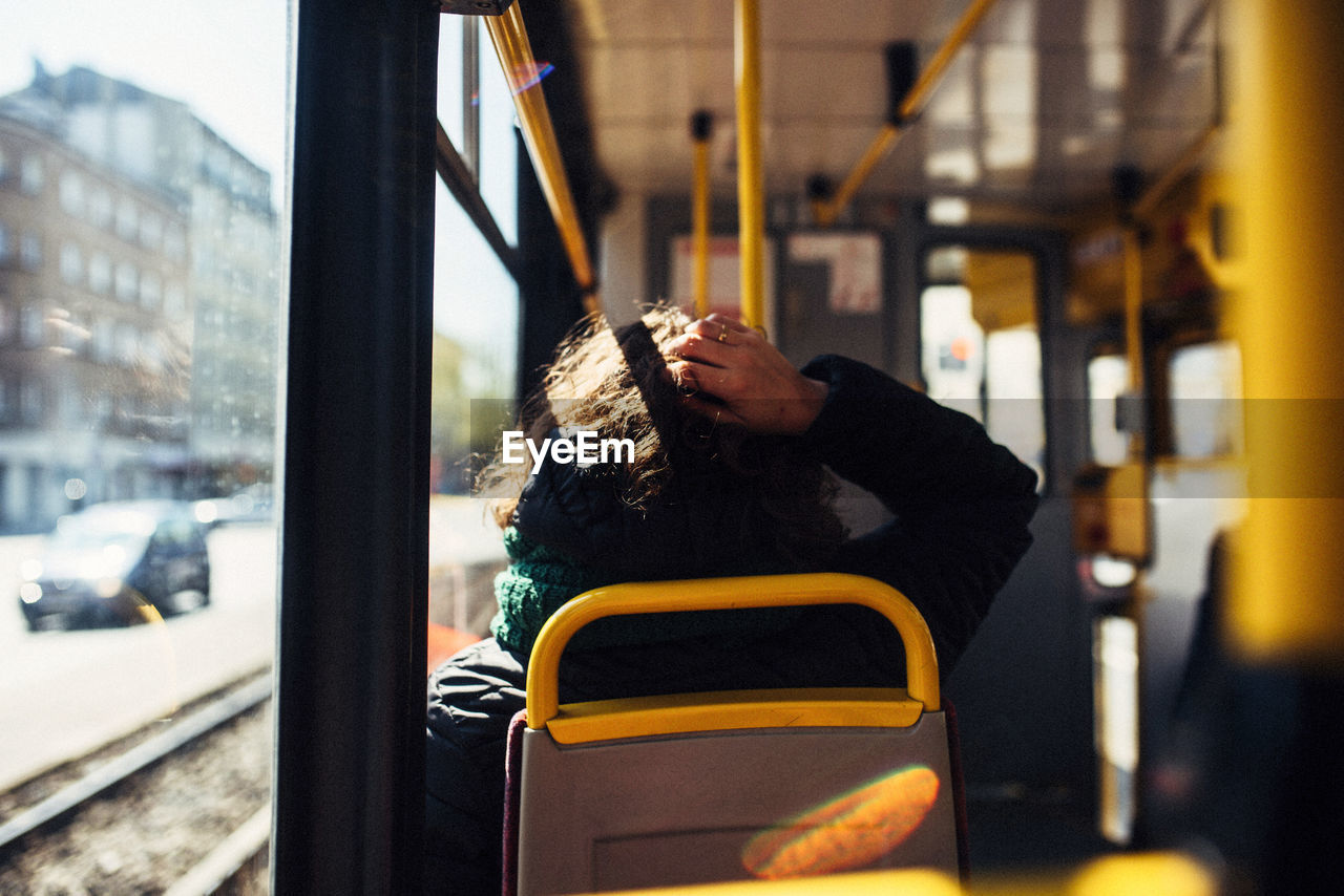 Rear view of man traveling in train