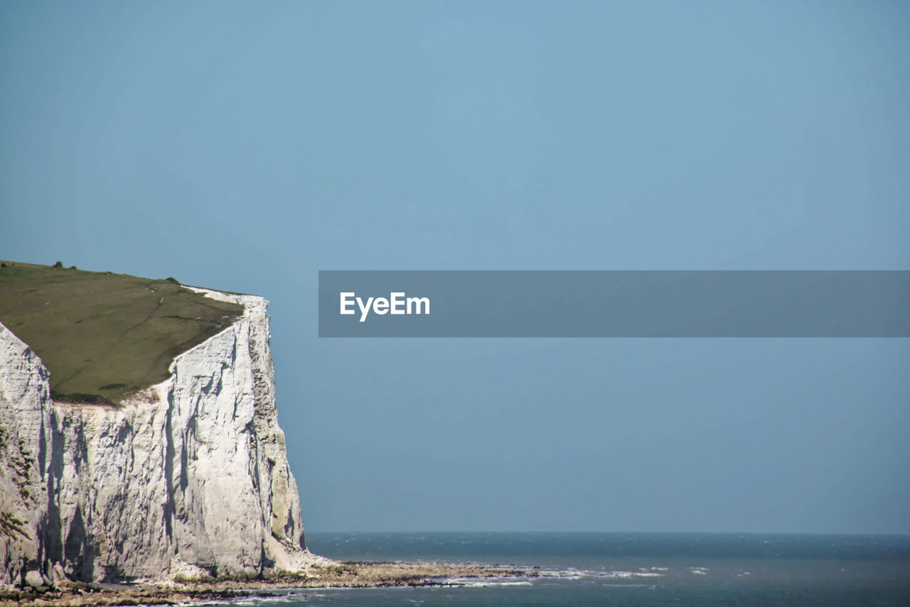 Scenic view of sea against clear blue sky