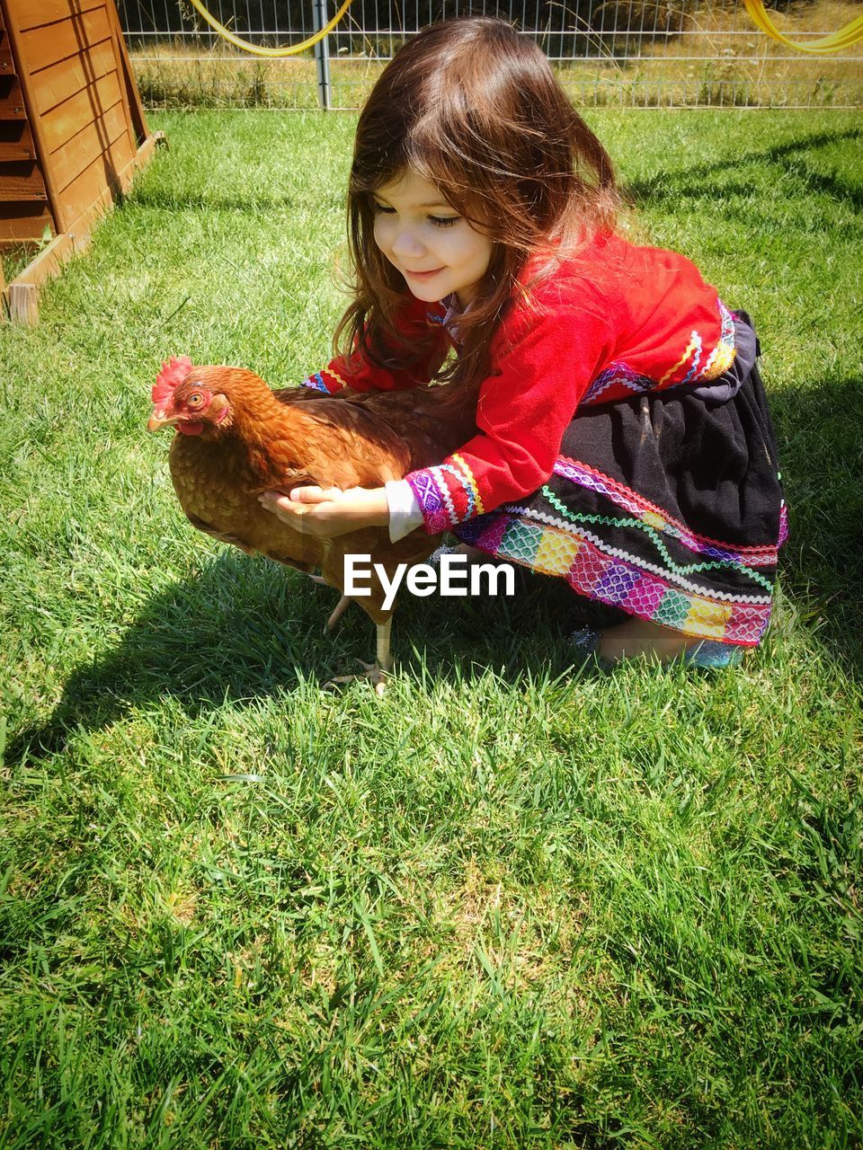 LITTLE GIRL PLAYING ON GRASSY FIELD