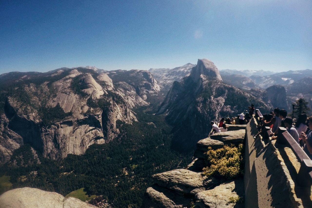 Tourists at observation point visiting yosemite national park on sunny day