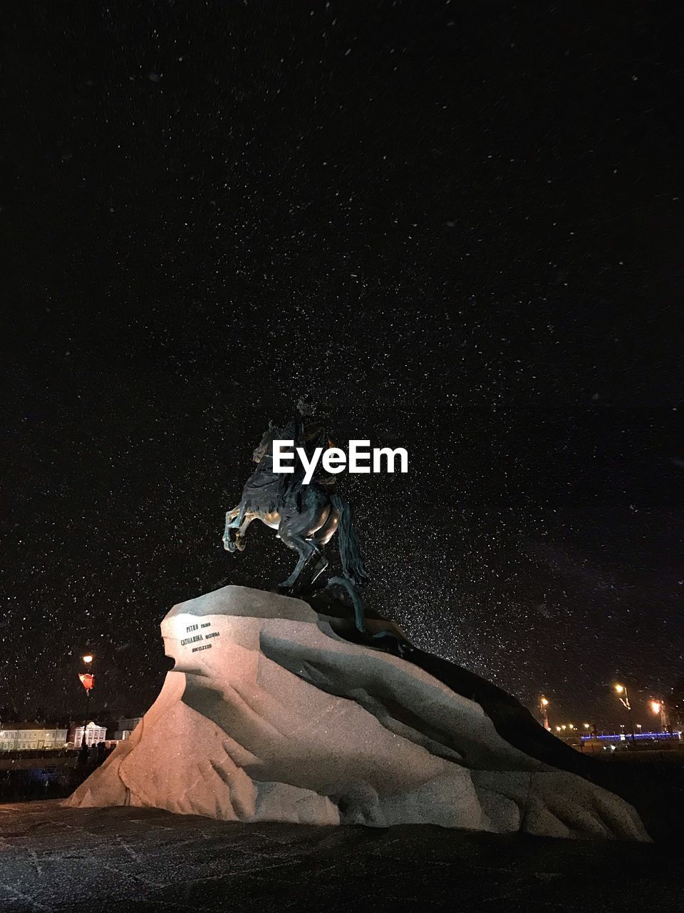 LOW ANGLE VIEW OF ILLUMINATED STATUE AGAINST SKY