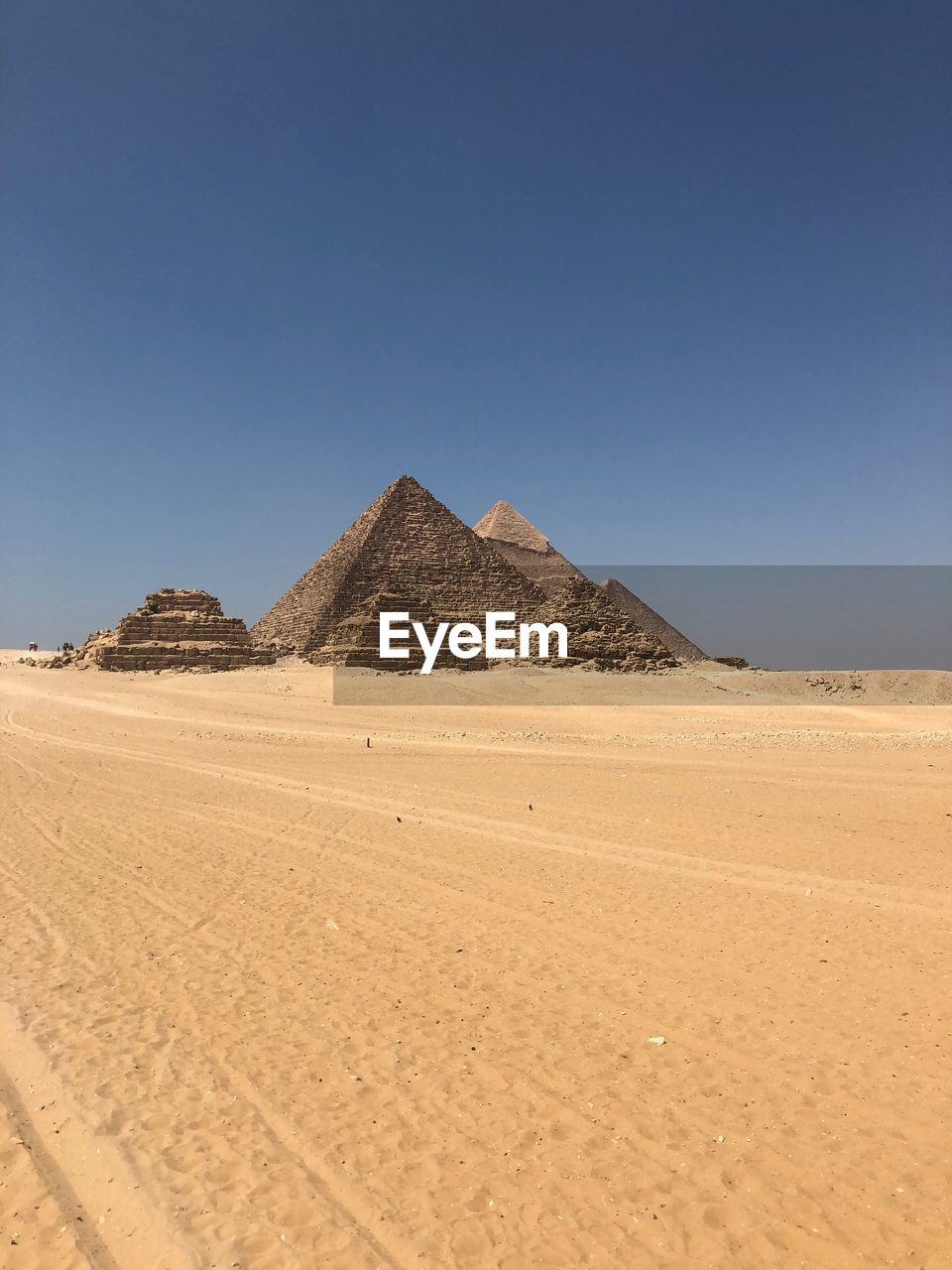 Pyramids at desert against clear sky
