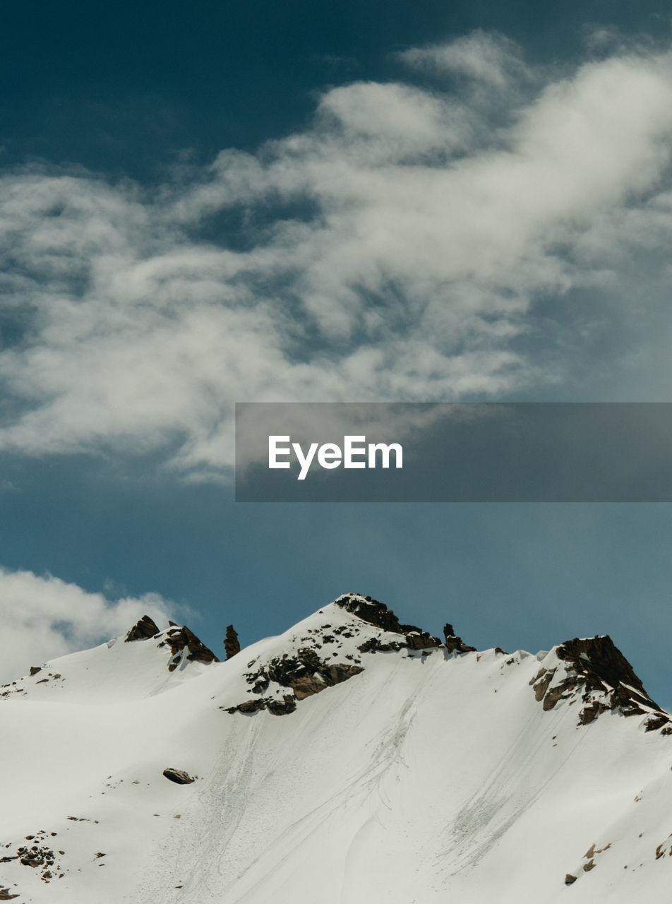 Snow covered mountains against sky