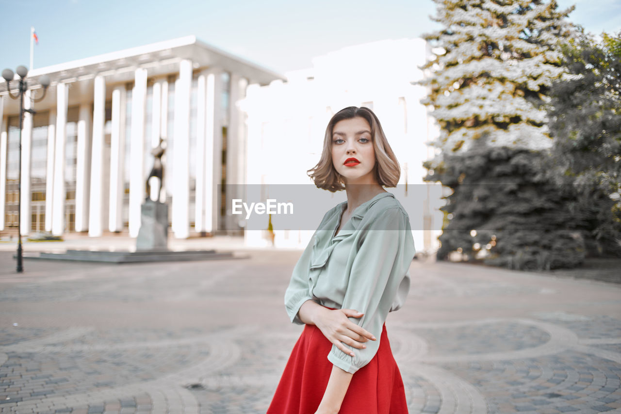 Portrait of beautiful young woman standing outdoors