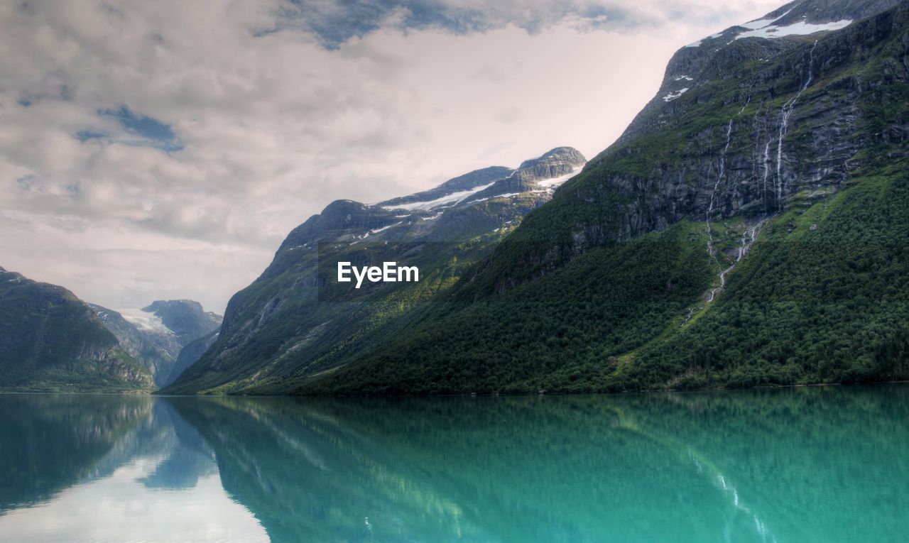 Scenic view of lake and mountains against sky