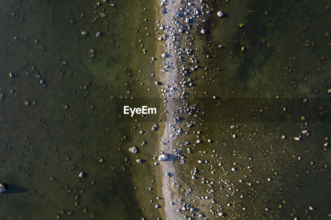 Seashore with rocks and water shot directly from above. 