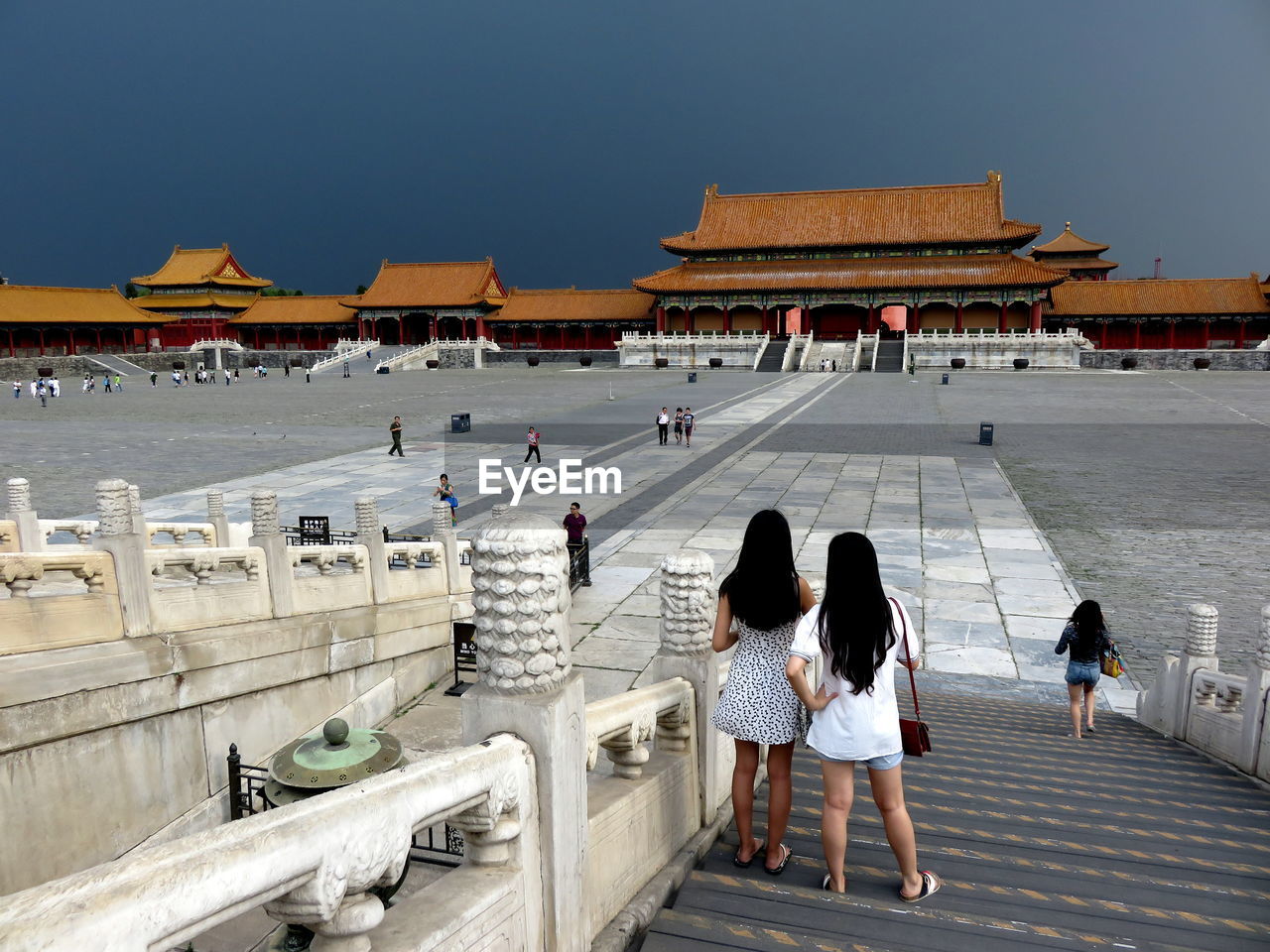 People at forbidden city against overcast sky