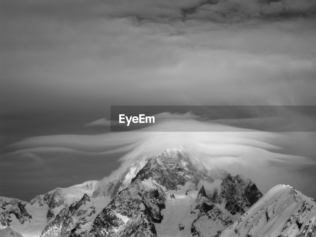 Scenic view of snow covered mountains against sky