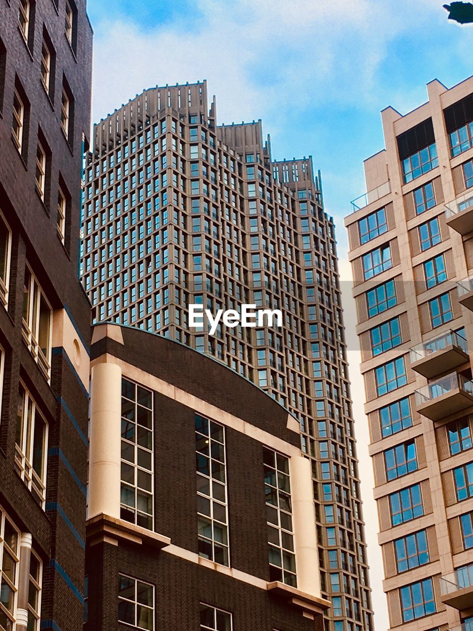 Low angle view of modern buildings in city against sky