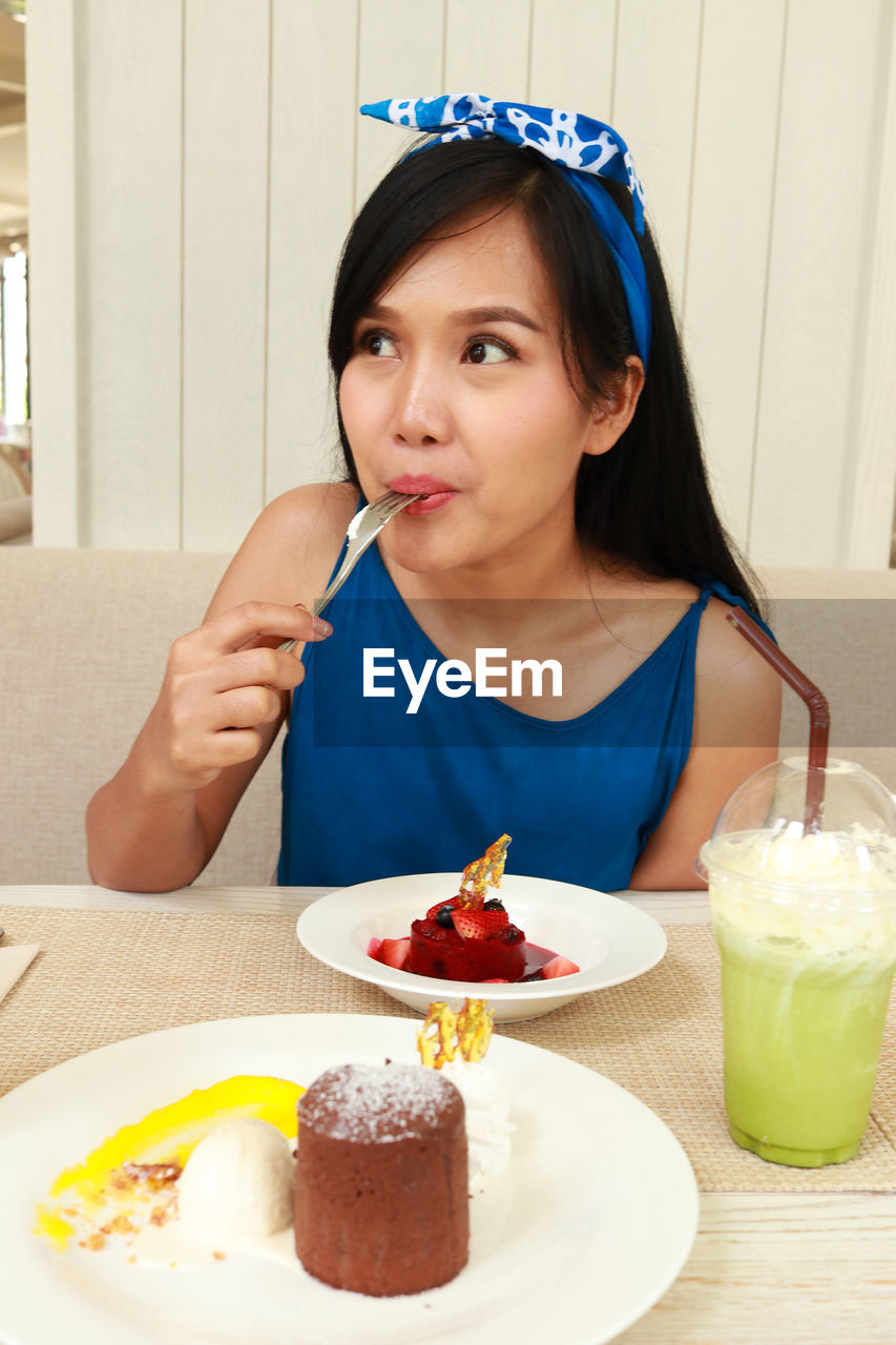 Woman eating dessert at restaurant